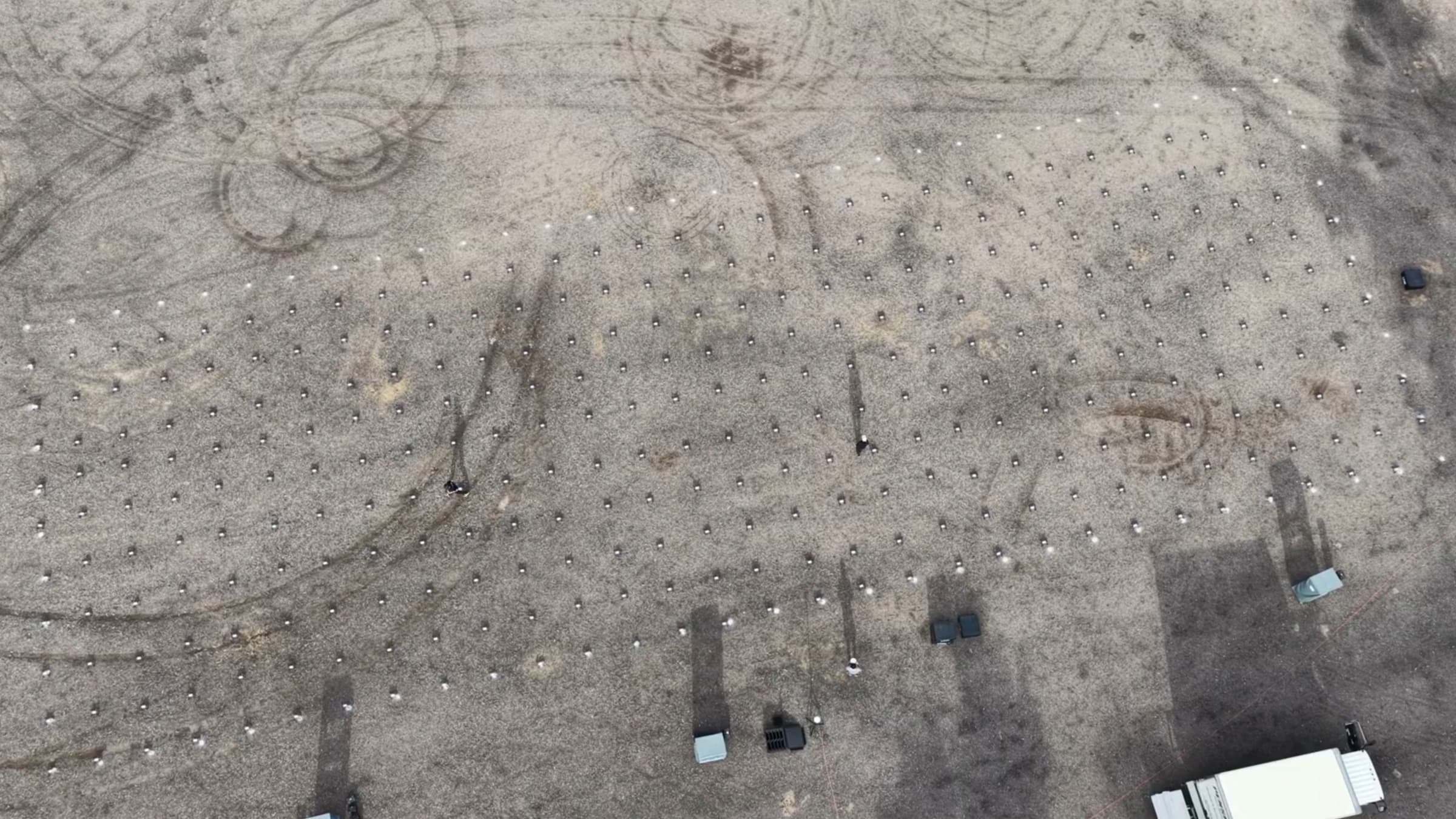 Pulse drones laid out in a grid on the ground before a show, each aircraft spaced on its launch position
